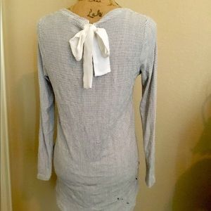 Striped shirt with bow in the back.